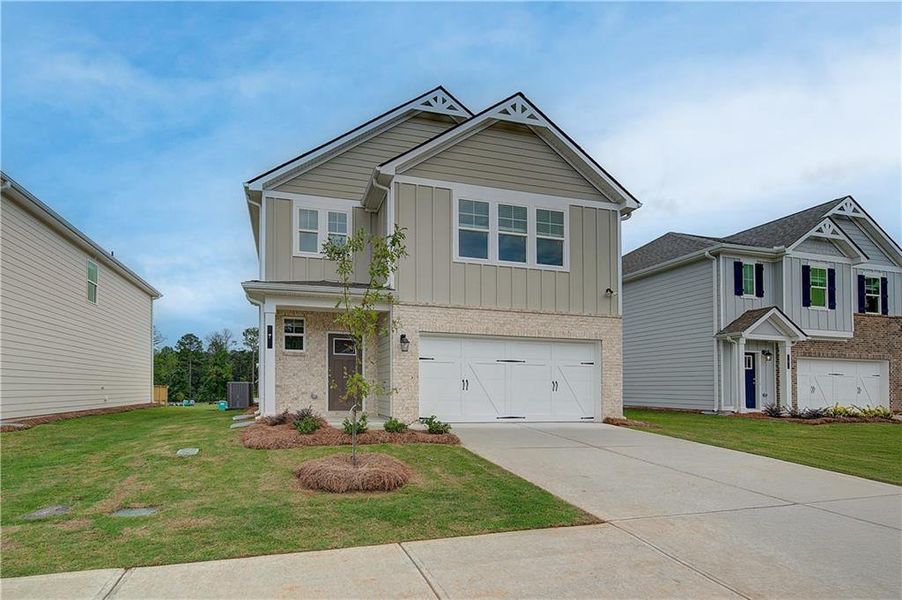 Front exterior of a new home in Enclave at Evergreen, Fairburn, GA, highlighting curb appeal (Image 14). Front exterior of a new home in Enclave at Evergreen, Fairburn, GA, highlighting curb appeal (Image 14).