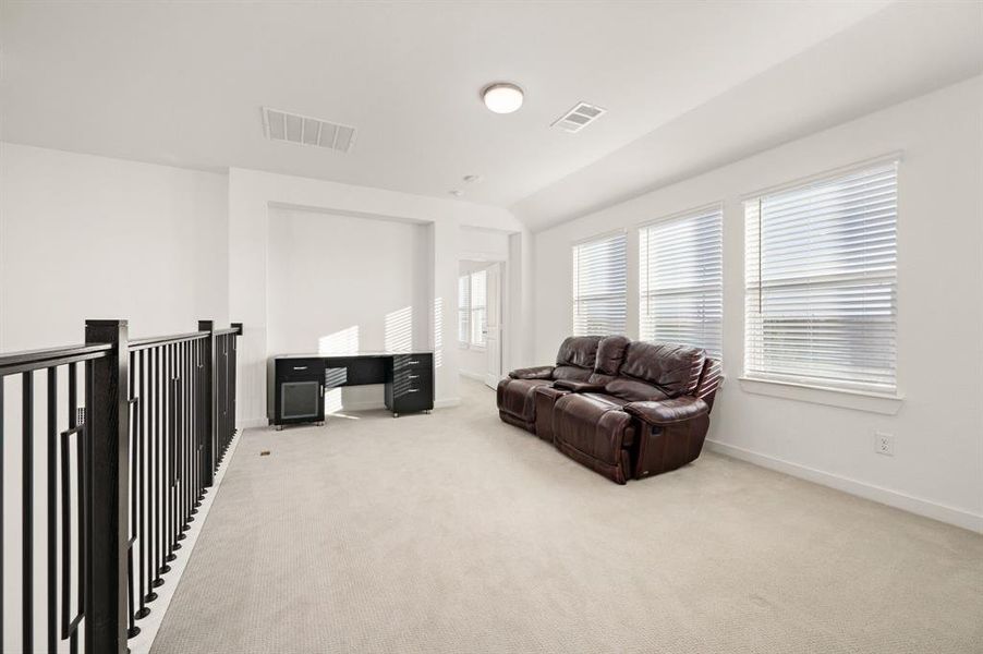 Living area with light carpet and baseboards