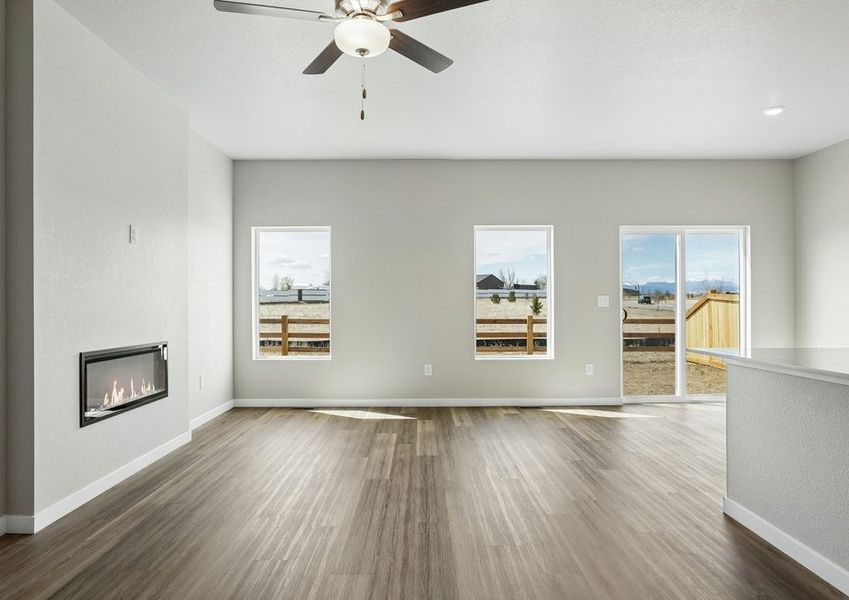 The family room is spacious with a ceiling fan and an electric fireplace.