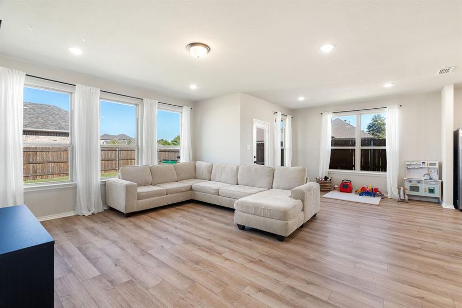 Living room featuring light wood-style floors and recessed lighting Living room featuring light wood-style floors and recessed lighting