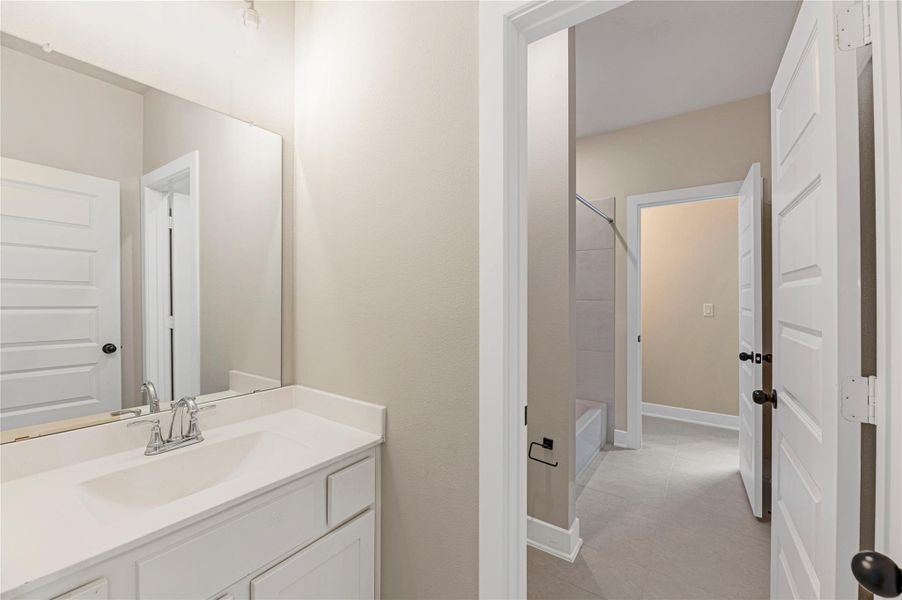 Full bathroom featuring vanity, shower / washtub combination, and light tile patterned floors