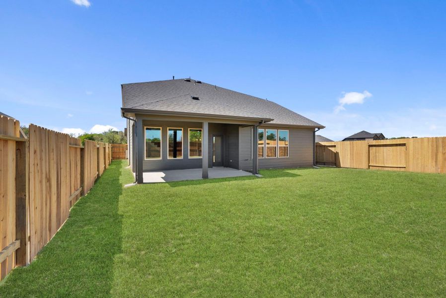 Exterior details and patio area of a home in Trinity Grove, Spring (Image 4).