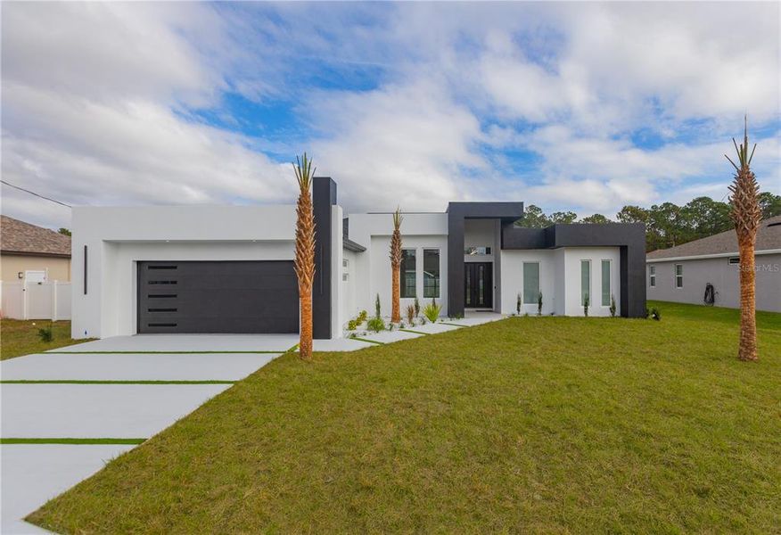 Front exterior of a new home in , Palm Coast, FL, highlighting curb appeal (Image 21). Front exterior of a new home in , Palm Coast, FL, highlighting curb appeal (Image 21).