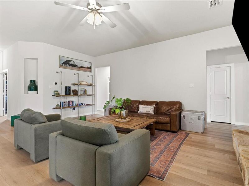 Open-concept living room with abundant natural light, ideal for entertaining and everyday living.