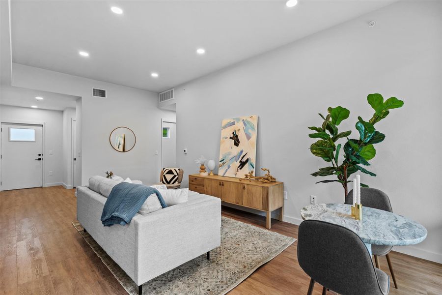 Living room with visible vents and light wood finished floors