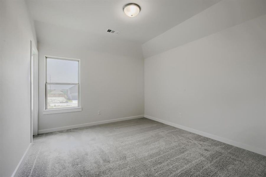Room featuring light gray carpet flooring, white painted walls, and a single window with white trim