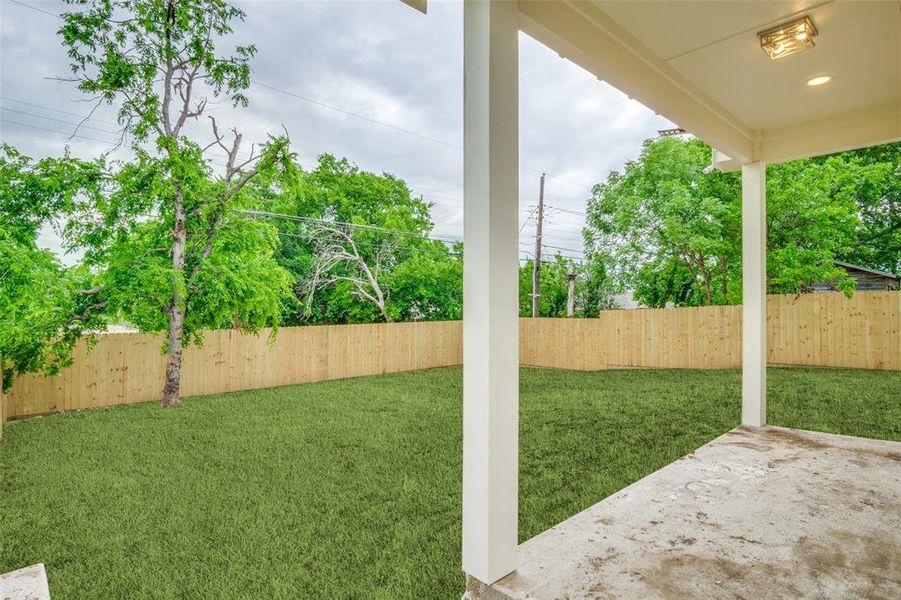 View of yard with a fenced backyard and a patio area