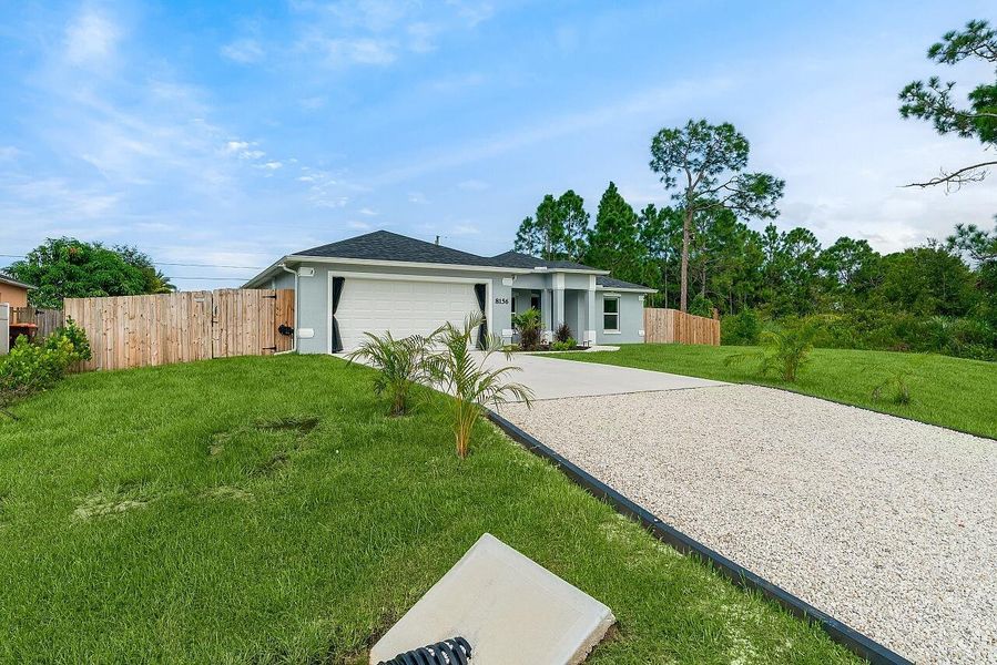 Front exterior of a new home in , Vero Beach, FL, highlighting curb appeal (Image 22). Front exterior of a new home in , Vero Beach, FL, highlighting curb appeal (Image 22).