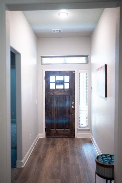 Entrance foyer with hardwood / wood-style floors