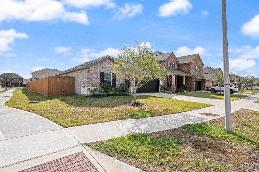 Front exterior of a new home in Sierra Vista, Iowa Colony, TX, highlighting curb appeal (Image 22).