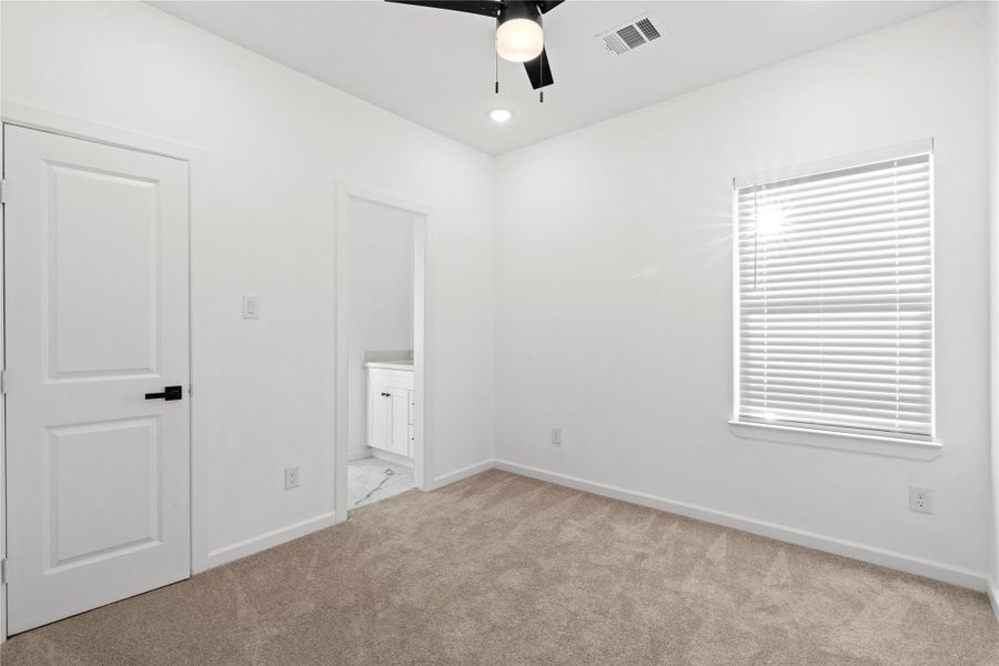 Secondary bedroom with ensuite access and great natural light—perfect for guests, a roommate, or an office. Secondary bedroom with ensuite access and great natural light—perfect for guests, a roommate, or an office.