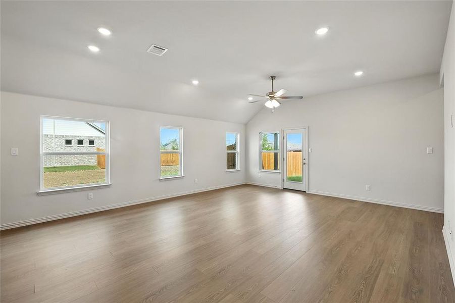 Spare room with light wood-style flooring, recessed lighting, lofted ceiling, and a ceiling fan Spare room with light wood-style flooring, recessed lighting, lofted ceiling, and a ceiling fan
