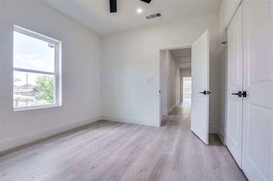 Unfurnished bedroom featuring light wood-style flooring, attic access, ceiling fan, a closet, and recessed lighting Unfurnished bedroom featuring light wood-style flooring, attic access, ceiling fan, a closet, and recessed lighting
