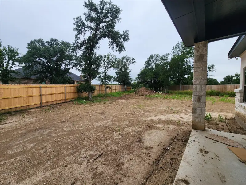 Expansive backyard space with a new wood privacy fence