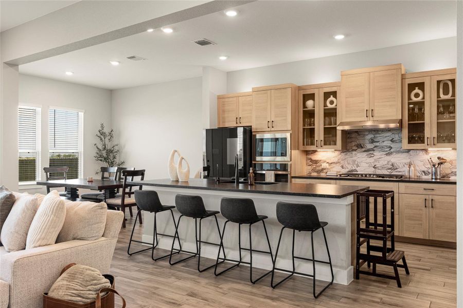 Culinary delights await in this modern kitchen with ample counter space and inviting breakfast bar seating. Culinary delights await in this modern kitchen with ample counter space and inviting breakfast bar seating.