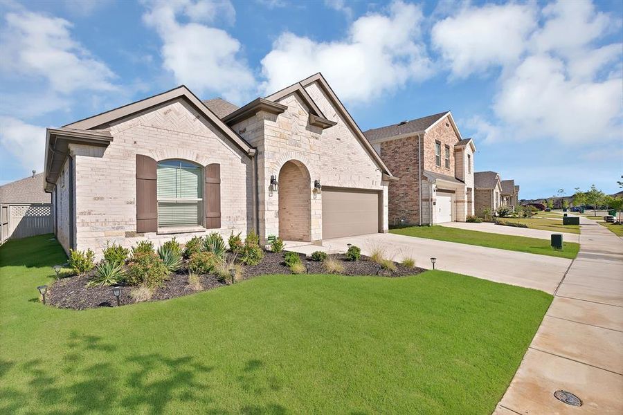 Front exterior of a new home in Pecan Square, Northlake, TX, highlighting curb appeal (Image 22).