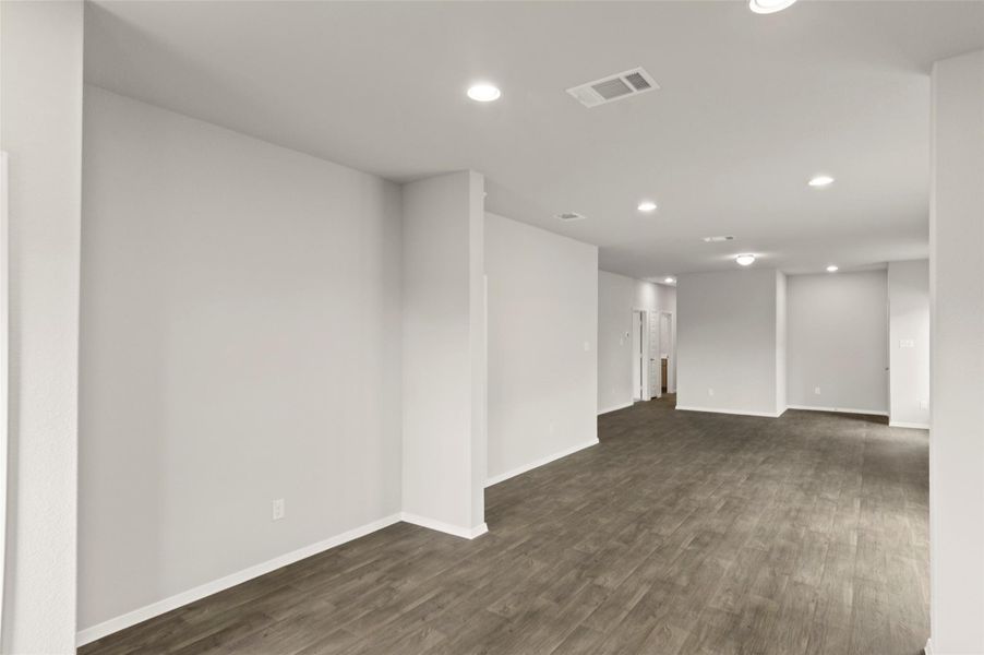 Spare room featuring recessed lighting and dark wood-style floors