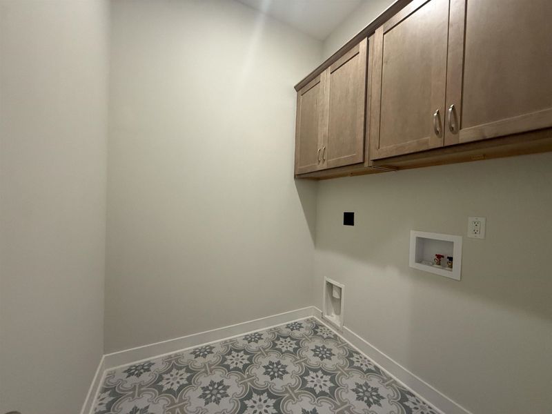 Laundry room featuring washer hookup and cabinet space