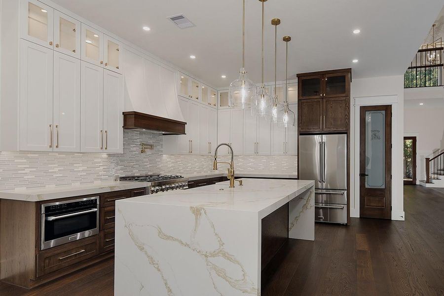 Sleek Appliances Include 6 Burner Gas Range, Undermount Microwave, Dishwasher and Refrigerator. Access to a Truly Impressive Walk-in Pantry with Abundant Shelving and Counterspace Sleek Appliances Include 6 Burner Gas Range, Undermount Microwave, Dishwasher and Refrigerator. Access to a Truly Impressive Walk-in Pantry with Abundant Shelving and Counterspace