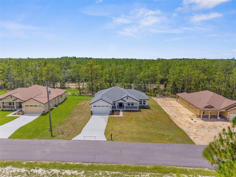 Front exterior of a new home in , Weeki Wachee, FL, highlighting curb appeal (Image 37).