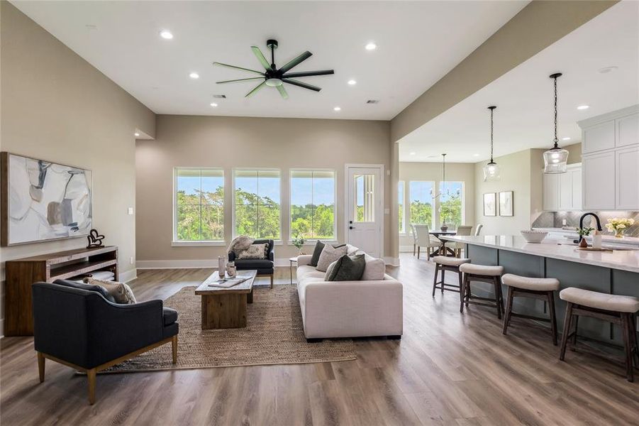 Family room has high ceilings, and large windows that provide abundant natural light. The kitchen boasts a large island with seating Family room has high ceilings, and large windows that provide abundant natural light. The kitchen boasts a large island with seating