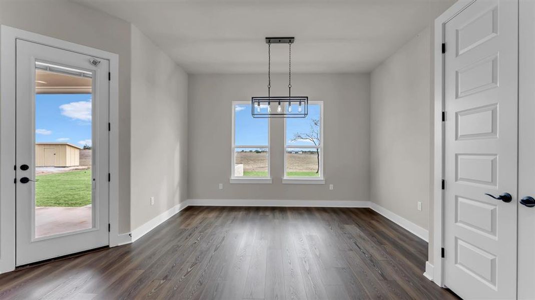 Rich wood floors lay a handsome foundation under a clean, minimalist dining room. Rich wood floors lay a handsome foundation under a clean, minimalist dining room.
