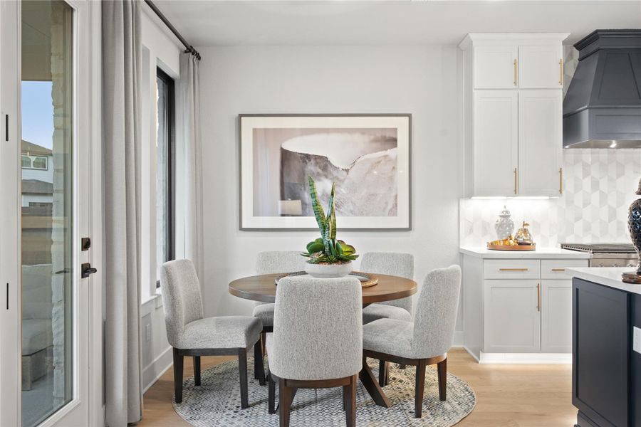 Breakfast area with light wood finished floors