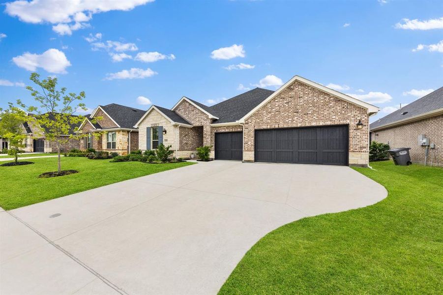 Front exterior of a new home in Valencia On The Lake, Little Elm, TX, highlighting curb appeal (Image 23). Front exterior of a new home in Valencia On The Lake, Little Elm, TX, highlighting curb appeal (Image 23).