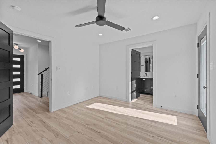 Unfurnished bedroom featuring recessed lighting, light wood-style floors, ceiling fan, and ensuite bathroom