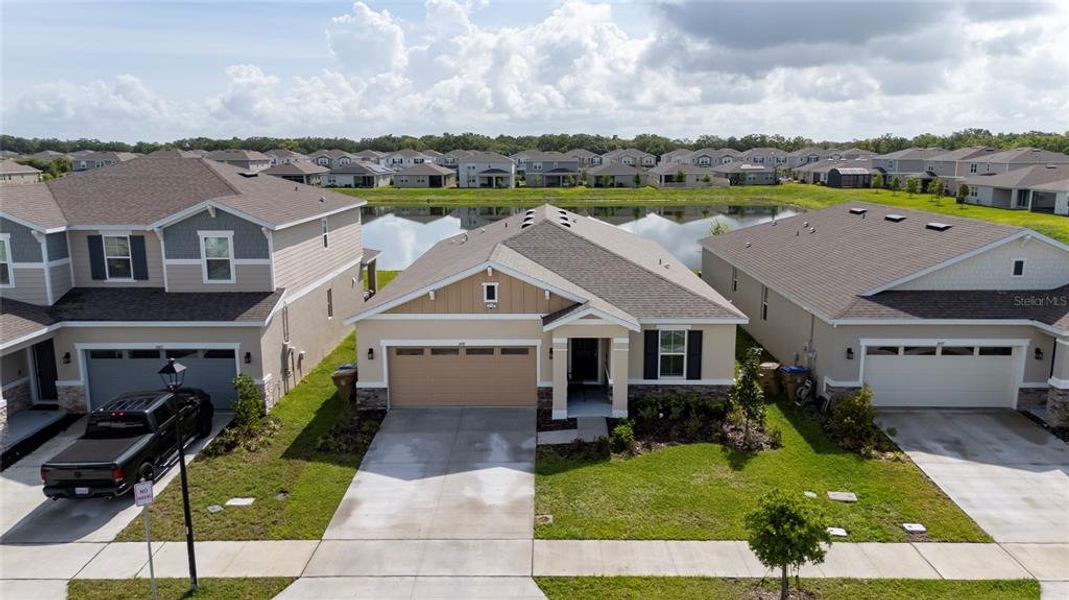 Front exterior of a new home in Seasons at Big Sky, Kissimmee, FL, highlighting curb appeal (Image 25).