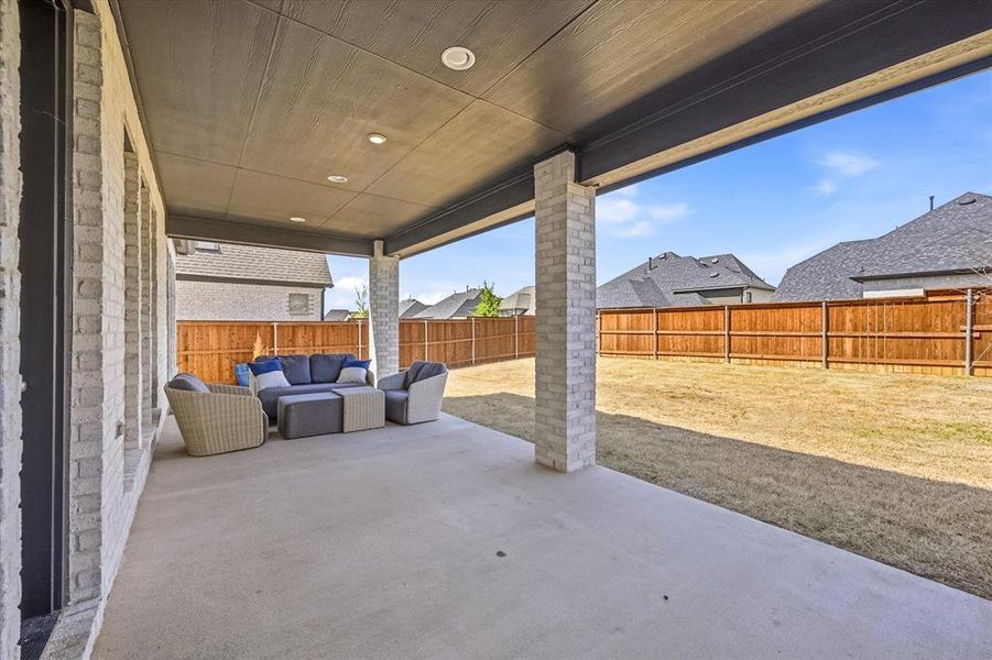 Fenced backyard with a patio area, & outdoor lounge area