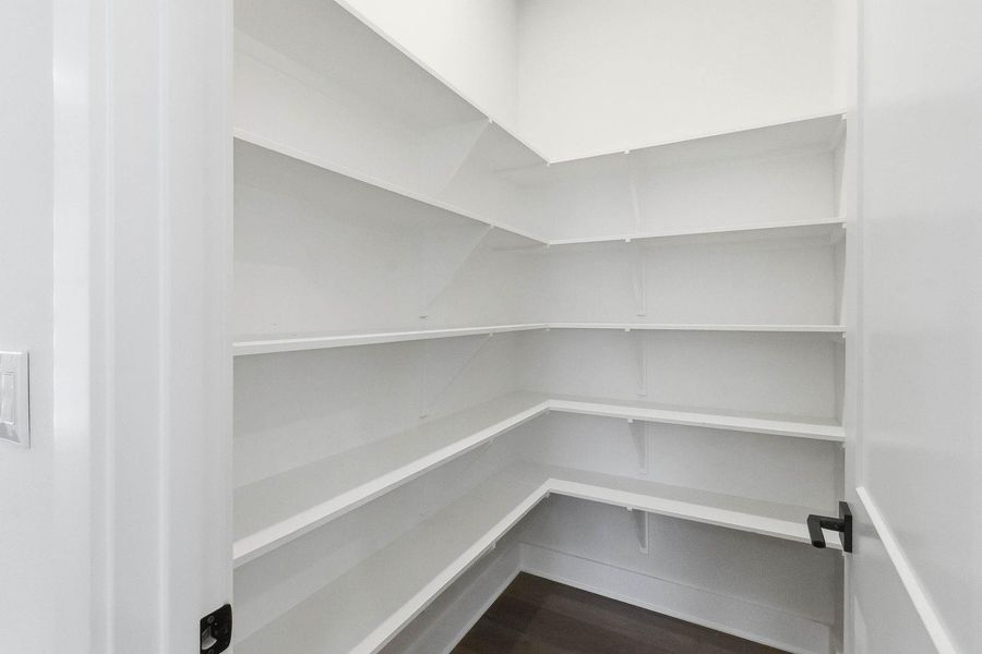 A well-organized pantry featuring ample shelving for storage convenience. A well-organized pantry featuring ample shelving for storage convenience.