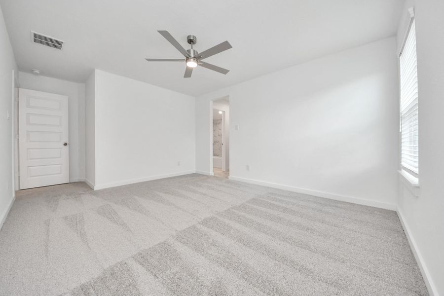 Generously sized secondary bedrooms featuring spacious closets, soft and inviting carpeting underfoot, large windows allowing plenty of natural light, and the added touch of privacy blinds for your personal retreat. Sample photo of completed home with similar floor plan. Actual colors and selections may vary.
