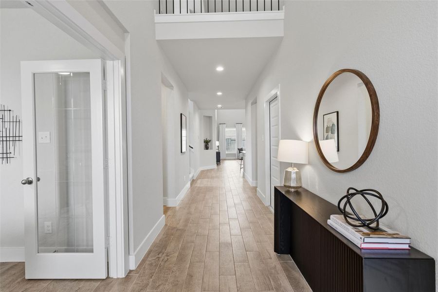 Step inside to your bright, soaring entryway with elevated ceilings, wood-look tile flooring, and a welcoming layout that sets the tone for the entire home.