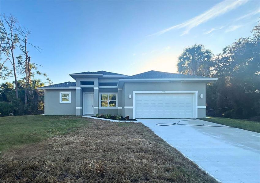 Front exterior of a new home in , North Port, FL, highlighting curb appeal (Image 1). Front exterior of a new home in , North Port, FL, highlighting curb appeal (Image 1).