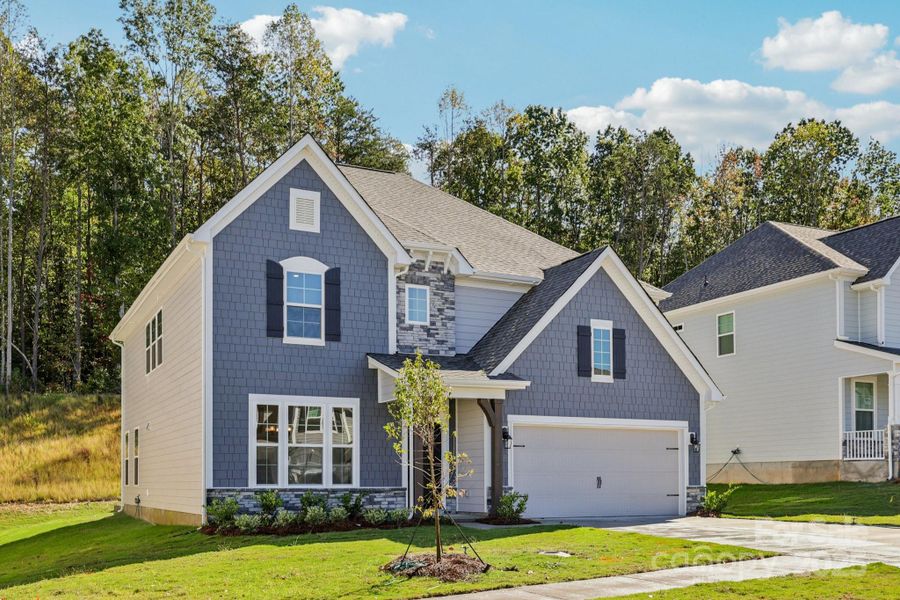 Front exterior of a new home in Falls Cove, Troutman, NC, highlighting curb appeal (Image 1).