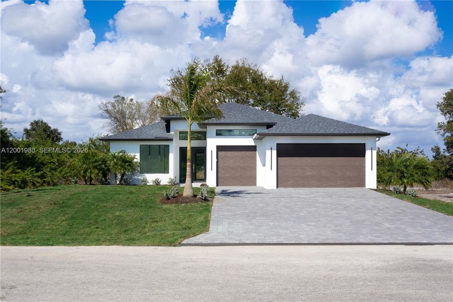 Front exterior of a new home in , Lehigh Acres, FL, highlighting curb appeal (Image 20).