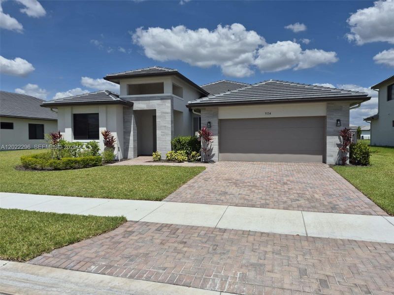 Front exterior of a new home in , Immokalee, FL, highlighting curb appeal (Image 2). Front exterior of a new home in , Immokalee, FL, highlighting curb appeal (Image 2).