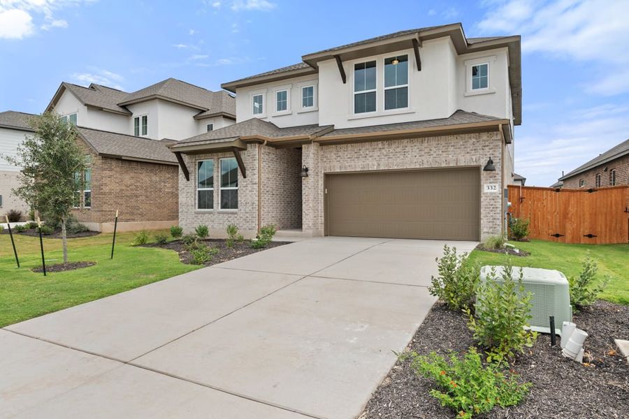 Front exterior of a new home in Arbor Collection at Lariat, Liberty Hill, TX, highlighting curb appeal (Image 2). Front exterior of a new home in Arbor Collection at Lariat, Liberty Hill, TX, highlighting curb appeal (Image 2).