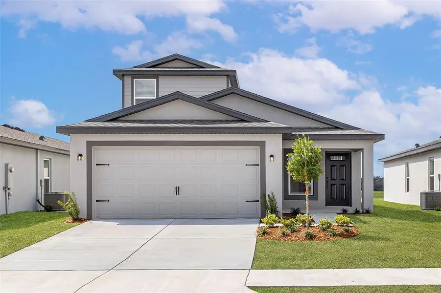 Front exterior of a new home in Fulton Meadows, Lakeland, FL, highlighting curb appeal (Image 1).
