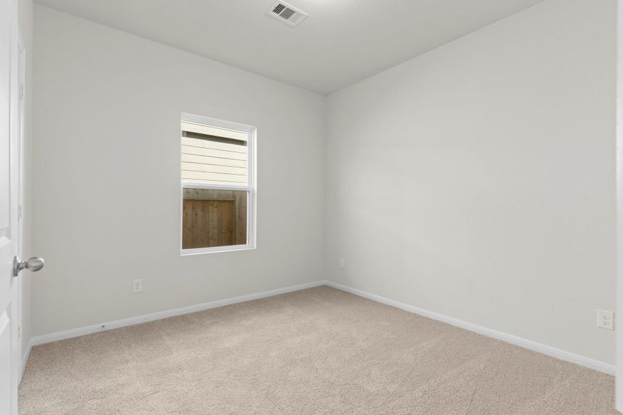 Cozy secondary bedroom with soft carpet flooring and a bright window offering natural light and privacy—an ideal retreat for guests or a peaceful home office. Cozy secondary bedroom with soft carpet flooring and a bright window offering natural light and privacy—an ideal retreat for guests or a peaceful home office.