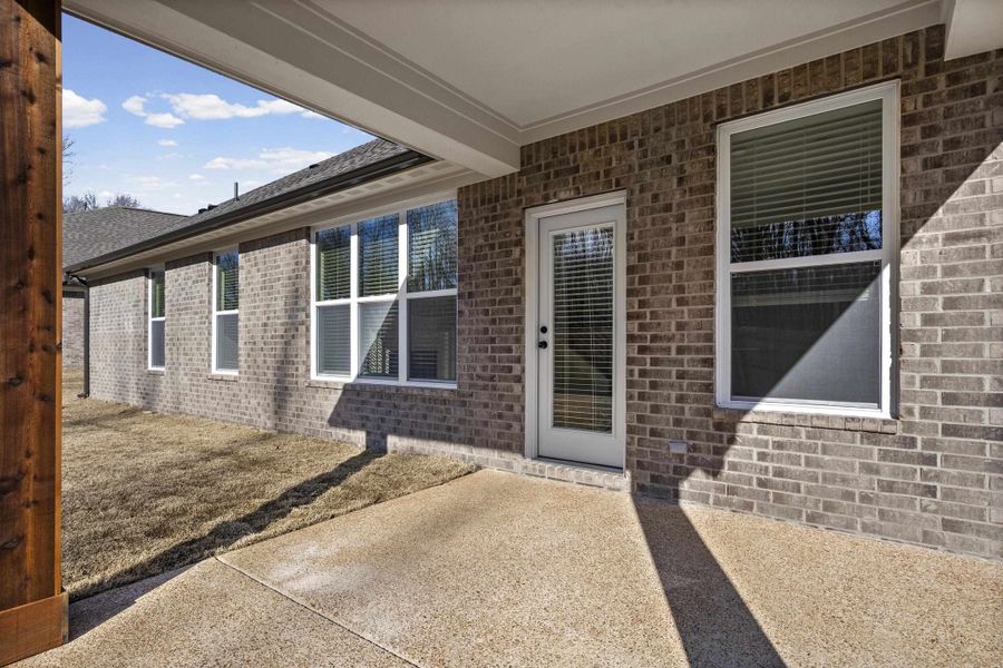 Doorway to property featuring a patio and brick siding Doorway to property featuring a patio and brick siding