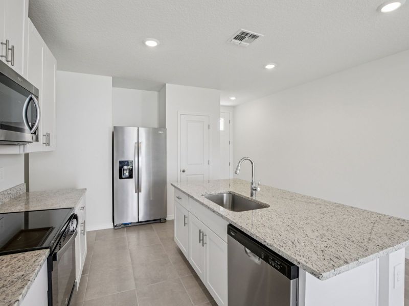 Furnished interior view inside a new home in The Grove at Stuart Crossing - Premier Series, Bartow (Image 5).