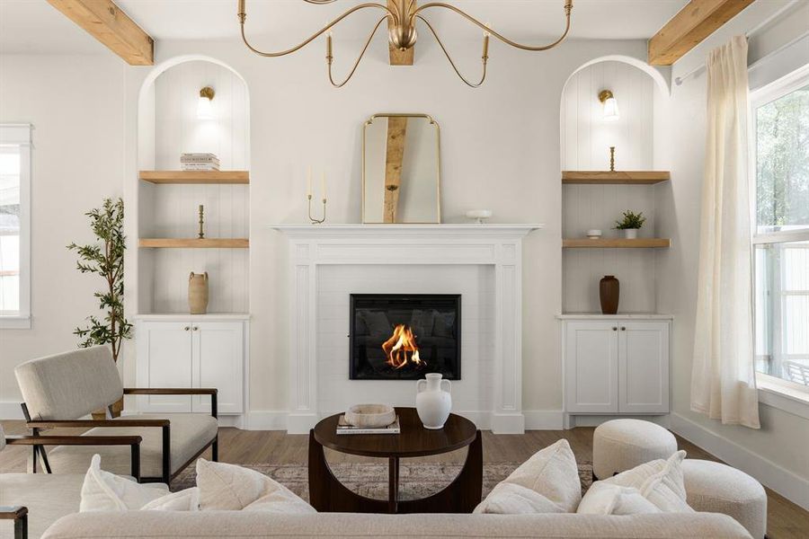 Living room with built in features, beam ceiling, and wood finished floors