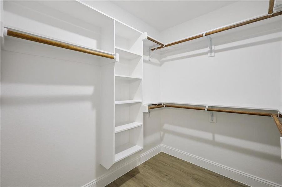 Spacious closet with light wood finished floors Spacious closet with light wood finished floors