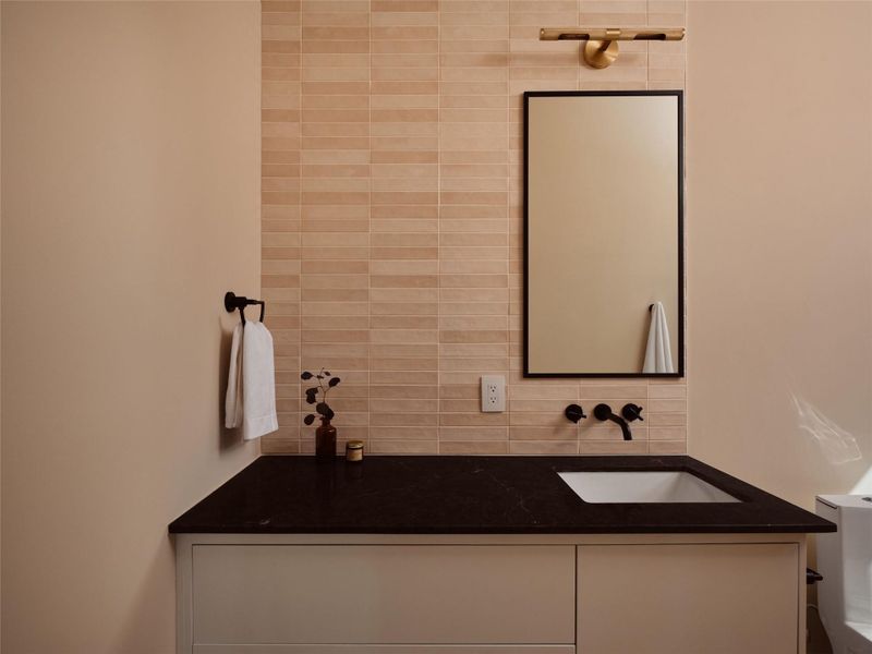 Bathroom with vanity and decorative backsplash