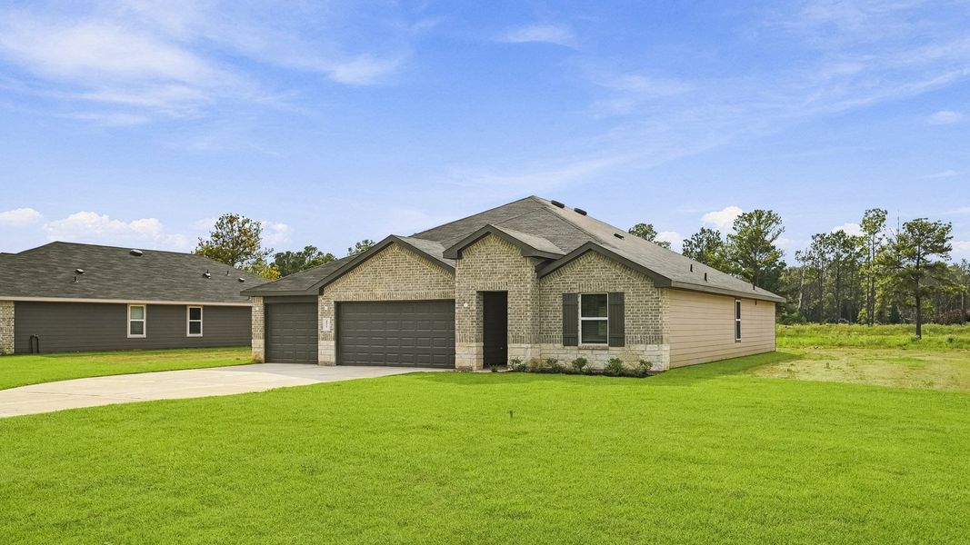 Front exterior of a new home in East Williams Cove, Conroe, TX, highlighting curb appeal (Image 2). Front exterior of a new home in East Williams Cove, Conroe, TX, highlighting curb appeal (Image 2).
