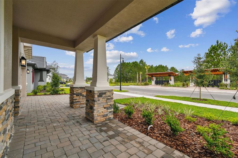 Front exterior of a new home in Tamarack at Two Rivers, Zephyrhills, FL, highlighting curb appeal (Image 12). Front exterior of a new home in Tamarack at Two Rivers, Zephyrhills, FL, highlighting curb appeal (Image 12).