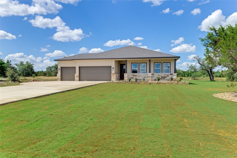 Front exterior of a new home in , Bertram, TX, highlighting curb appeal (Image 1).