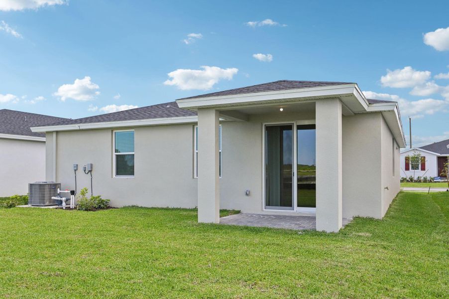 Front exterior of a new home in Hampton Park - Classic Series, Vero Beach, FL, highlighting curb appeal (Image 22). Front exterior of a new home in Hampton Park - Classic Series, Vero Beach, FL, highlighting curb appeal (Image 22).